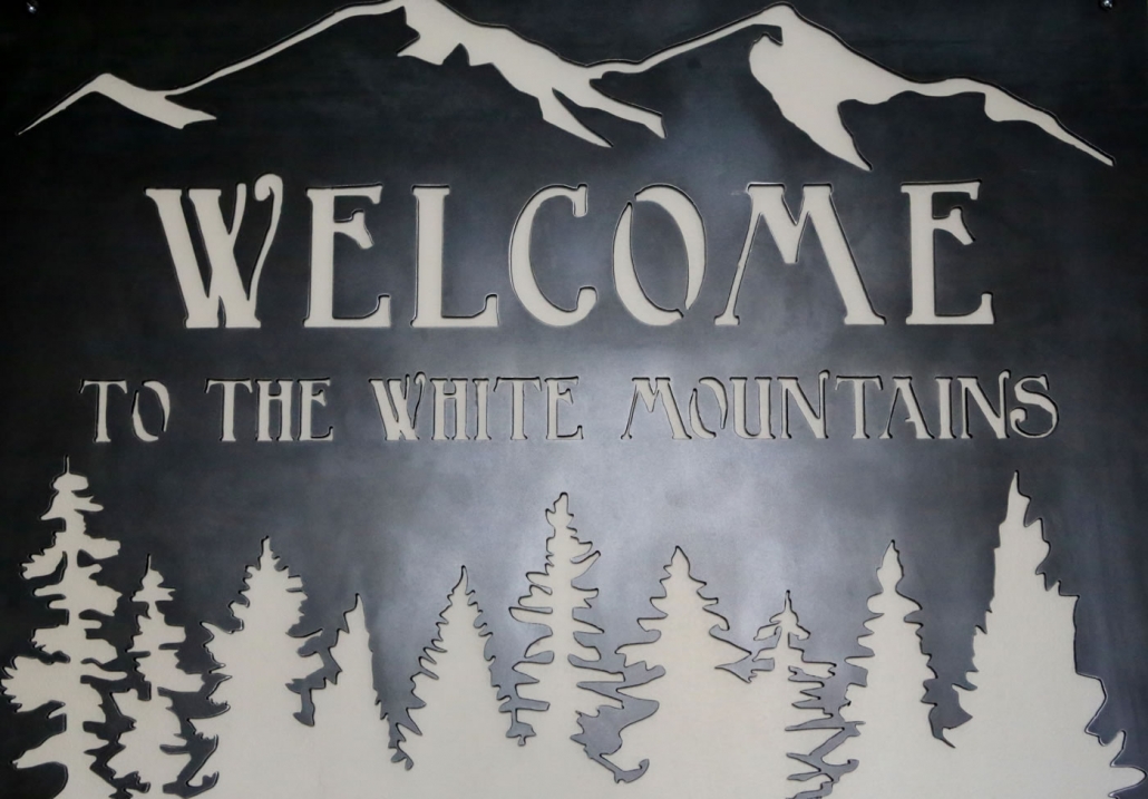 welcome to the white mountains sign nordic village